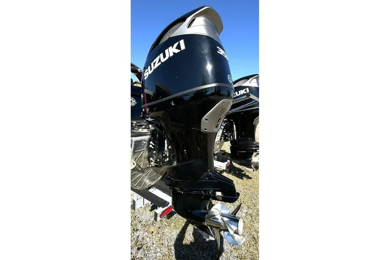 Slide: The Image of Outboard motor on a 2022 Manitou XT 27 SRW boat, featuring Suzuki branding. - 41
