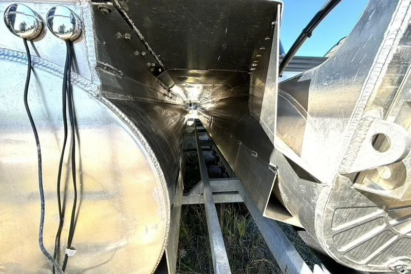 Slide: The Image of 2022 Manitou XT 27 SRW pontoon boat undercarriage, showcasing aluminum structure and wiring. - 43