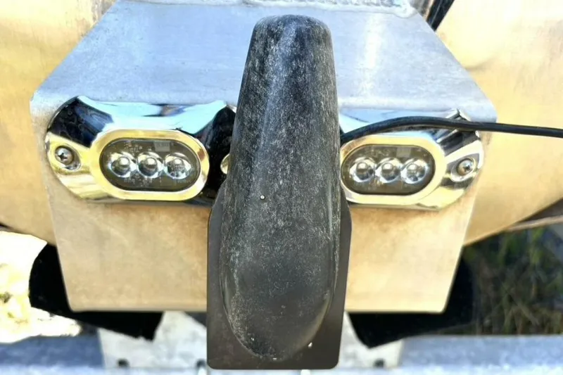 Slide: The Image of Close-up of 2022 Manitou XT 27 SRW boat's rear lights and towing hook. - 44