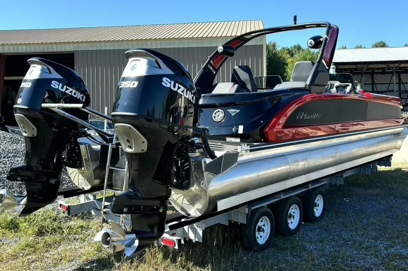 Slide: The Image of 2022 Manitou XT 27 SRW pontoon boat with dual Suzuki 350 engines on a trailer. - 6