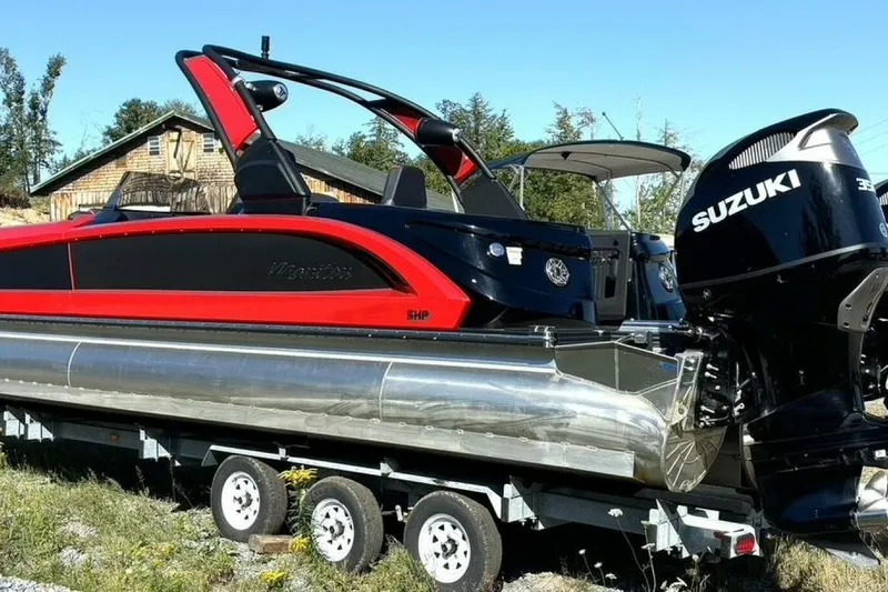 Slide: The Image of 2022 Manitou XT 27 SRW pontoon boat with Suzuki outboard motor on trailer. - 8