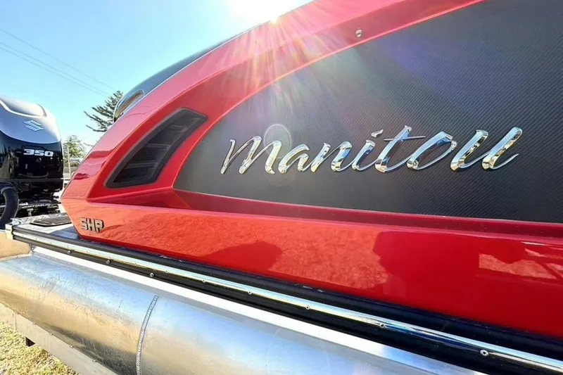 Slide: The Image of 2022 Manitou XT 27 SRW pontoon boat with sleek red design and Suzuki 350 engine. - 9