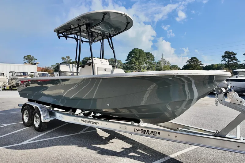 Slide: The Image of 2026 Carolina Skiff 24 Ultra Elite boat on Load Rite trailer, parked outdoors. - 4