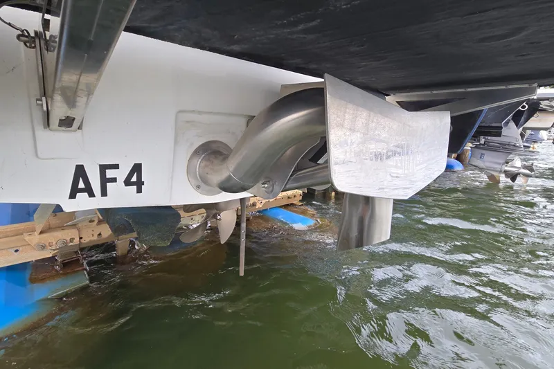 Slide: The Image of 2019 Axis T23 boat stern with propeller and exhaust system in water. - 10