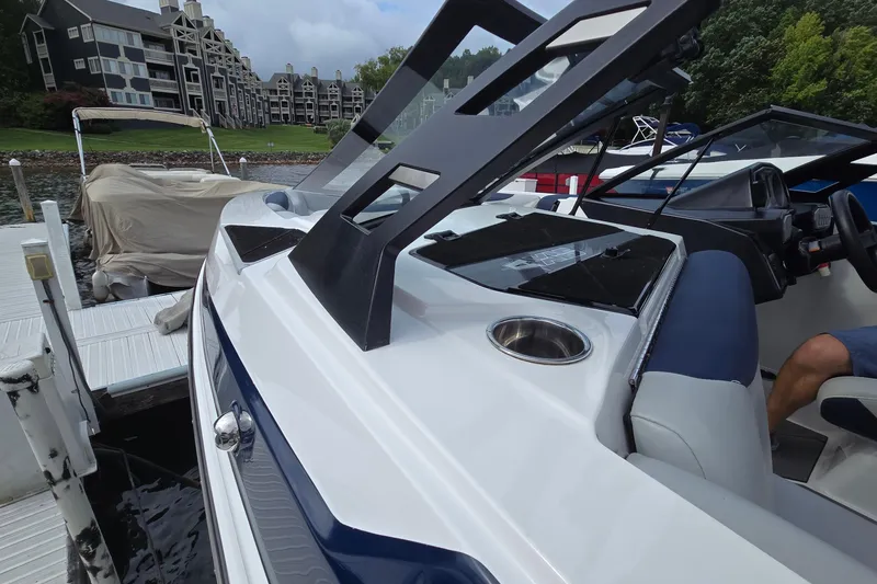 Slide: The Image of 2019 Axis T23 boat docked, featuring sleek design and modern interior, near waterfront buildings. - 17