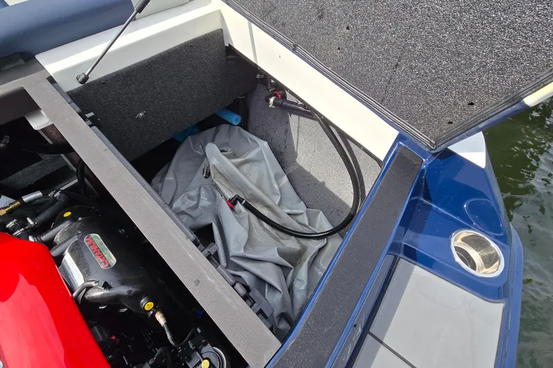 Slide: The Image of Open storage compartment in 2019 Axis T23 boat, showing engine and equipment. - 31