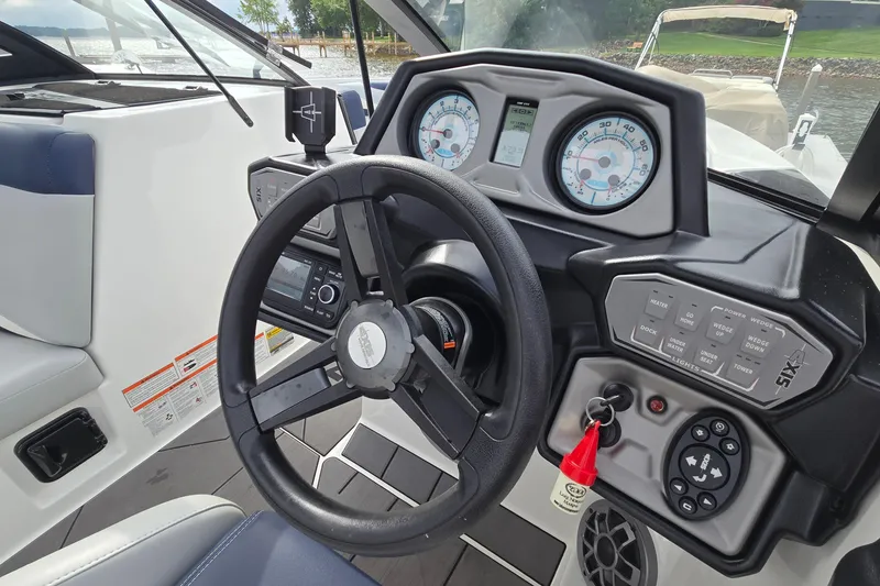 Slide: The Image of 2019 Axis T23 boat dashboard with steering wheel and control panel. - 32