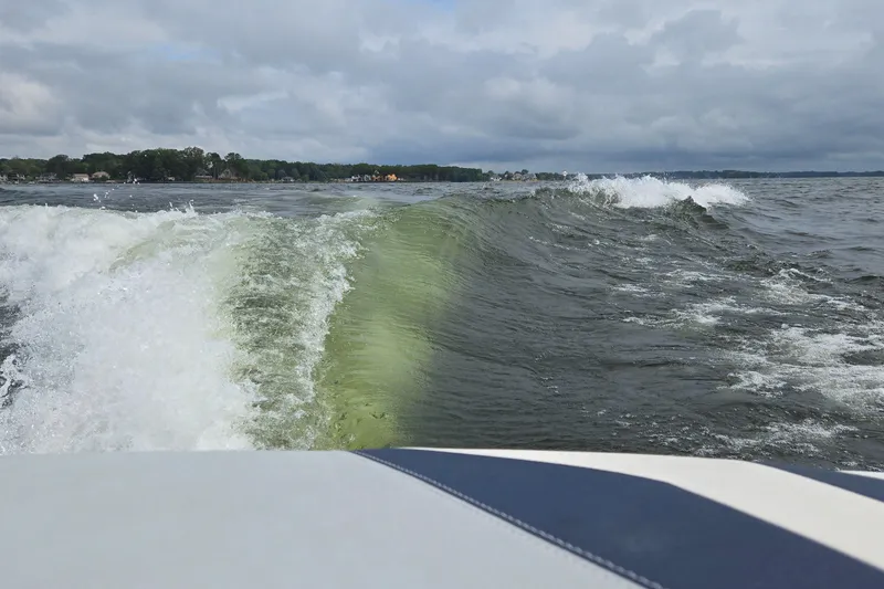 Slide: The Image of Wake created by a 2019 Axis T23 boat on a cloudy lake. - 44