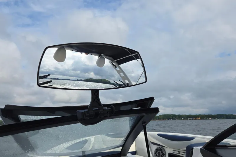 Slide: The Image of 2019 Axis T23 boat with rearview mirror reflecting lake and cloudy sky. - 46