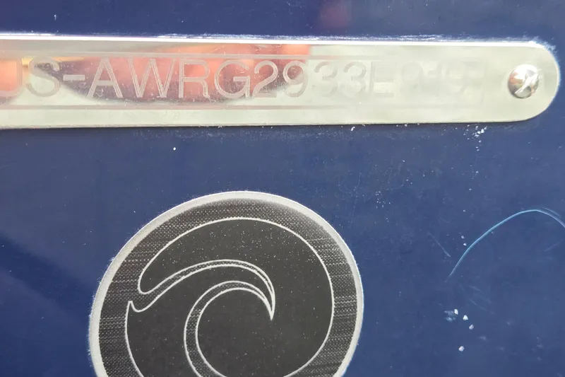 Slide: The Image of 2019 Axis T23 boat identification plate with logo on blue surface. - 50