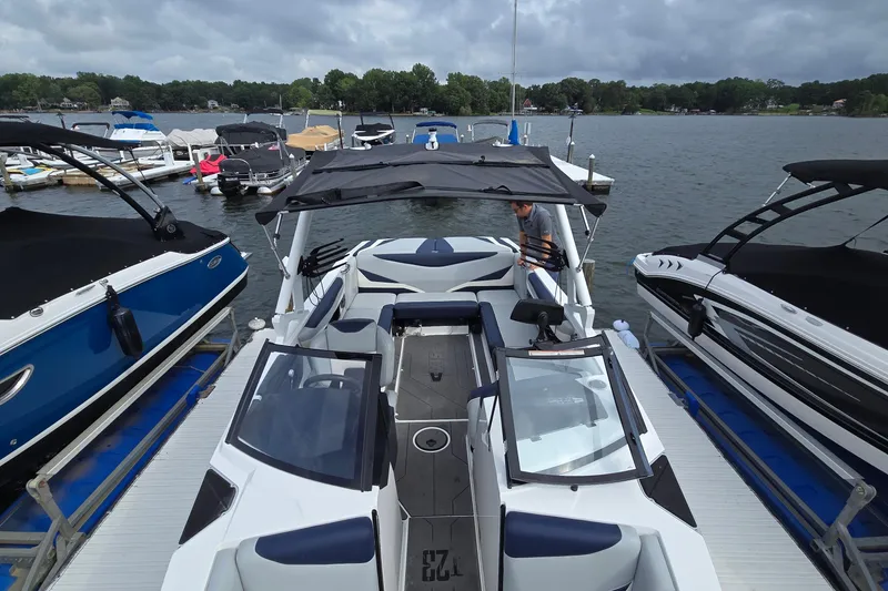 Slide: The Image of 2019 Axis T23 boat docked among other boats on a cloudy day. - 9
