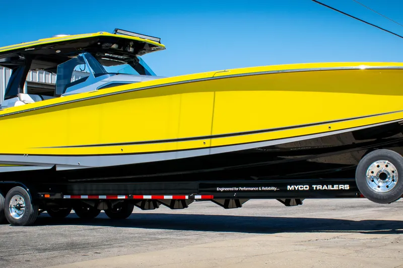 The Image of 2021 Nor-Tech 450 Sport boat in vibrant yellow on a Myco trailer. - 0