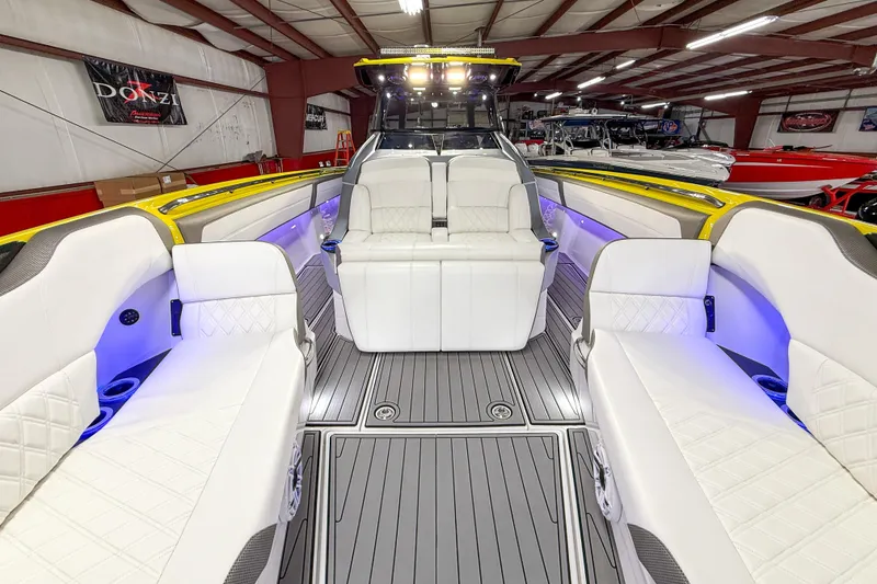 Slide: The Image of Luxurious 2021 Nor-Tech 450 Sport boat interior with white seating and ambient lighting. - 13