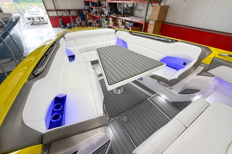 Slide: The Image of Luxurious 2021 Nor-Tech 450 Sport boat interior with white seating and ambient blue lighting. - 16