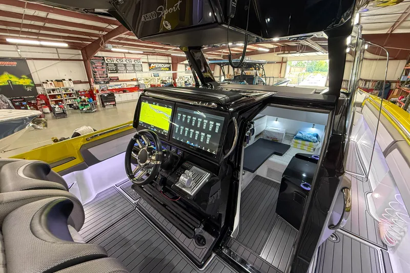 Slide: The Image of 2021 Nor-Tech 450 Sport boat interior with advanced navigation system and luxurious cabin. - 23