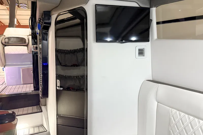 Slide: The Image of Interior of 2021 Nor-Tech 450 Sport boat with modern seating and wall-mounted TV. - 28