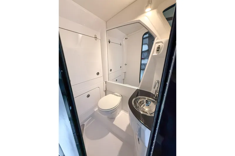 Slide: The Image of 2021 Nor-Tech 450 Sport boat bathroom with modern fixtures and sleek design. - 33