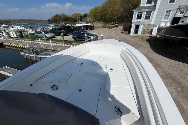 Slide: The Image of 2021 Regulator 24XO boat stern view at marina with outboard motor. - 10