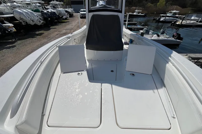 Slide: The Image of 2021 Regulator 24XO boat with open storage compartment, docked at a scenic marina. - 12