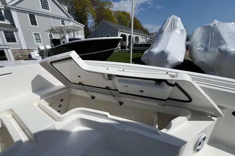 Slide: The Image of 2021 Regulator 24XO boat docked at marina with scenic waterfront view. - 14