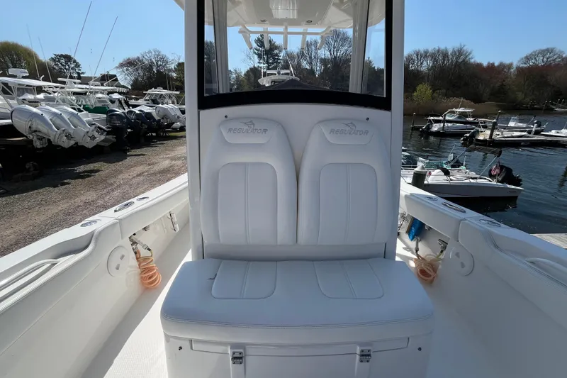 Slide: The Image of 2021 Regulator 24XO boat docked at a marina with scenic waterfront view. - 16