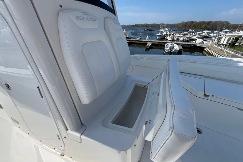 Slide: The Image of 2021 Regulator 24XO boat docked at a marina with other vessels. - 17
