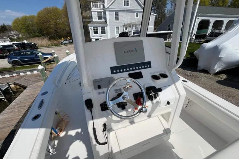 Slide: The Image of 2021 Regulator 24XO boat with open storage compartment at marina. - 19