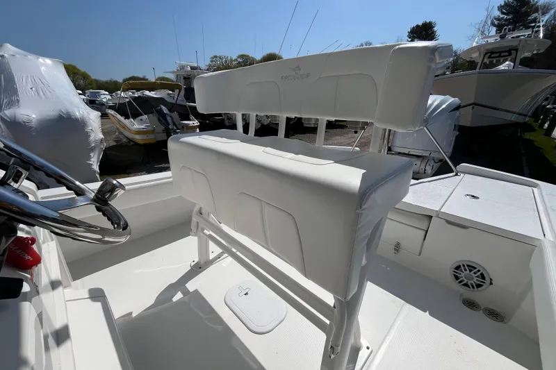 Slide: The Image of Open storage compartment on a 2021 Regulator 24XO boat, with covered boats in background. - 20