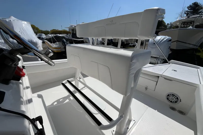 Slide: The Image of 2021 Regulator 24XO boat interior with open storage compartments at a dock. - 21