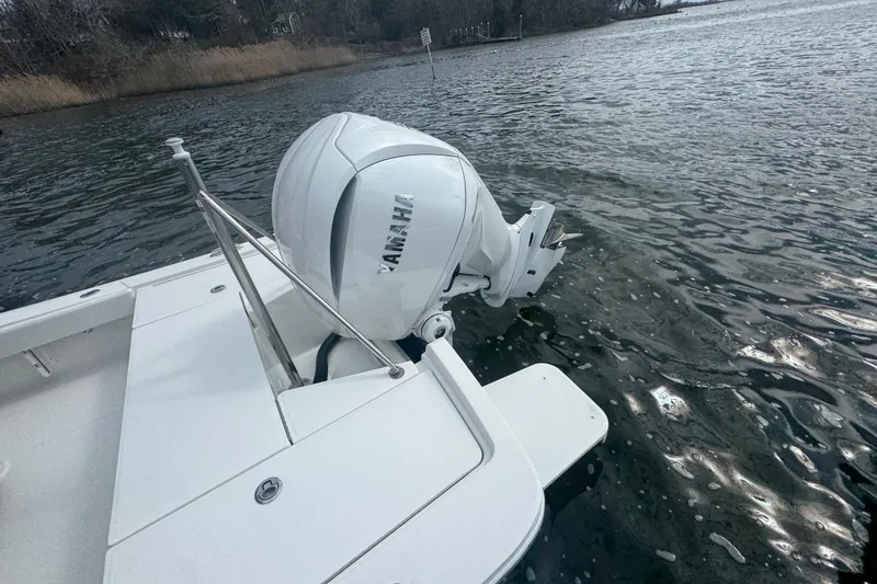 Slide: The Image of 2021 Regulator 24XO boat interior with white seating and steering wheel. - 26