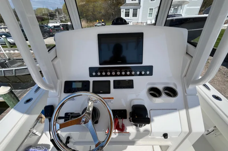 Slide: The Image of 2021 Regulator 24XO boat dashboard with steering wheel and electronic controls. - 28