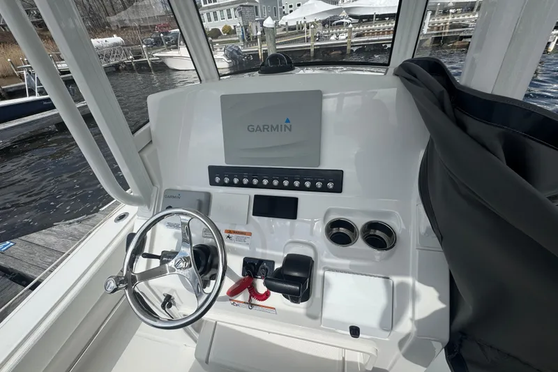Slide: The Image of 2021 Regulator 24XO boat helm with Garmin navigation system and steering wheel. - 3