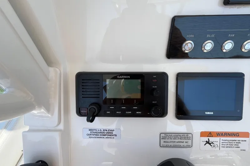 Slide: The Image of Control panel of a 2021 Regulator 24XO boat featuring Garmin and Yamaha displays. - 30