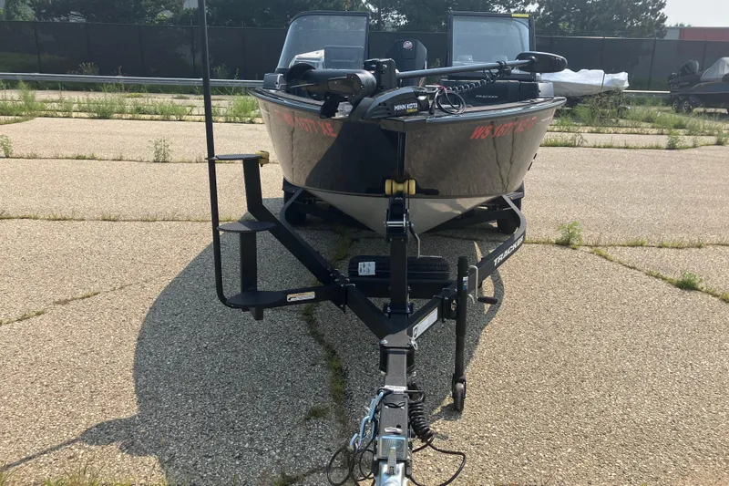 Slide: The Image of 2025 Tracker Targa V-19 Combo boat on trailer, parked on paved surface. - 4