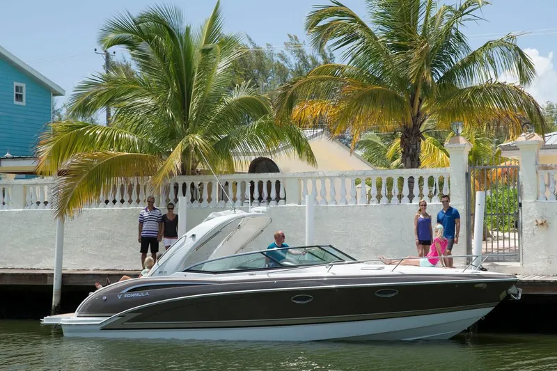 Slide: The Image of 2018 Formula 310 Sun Sport boat docked near a tropical waterfront home. - 28