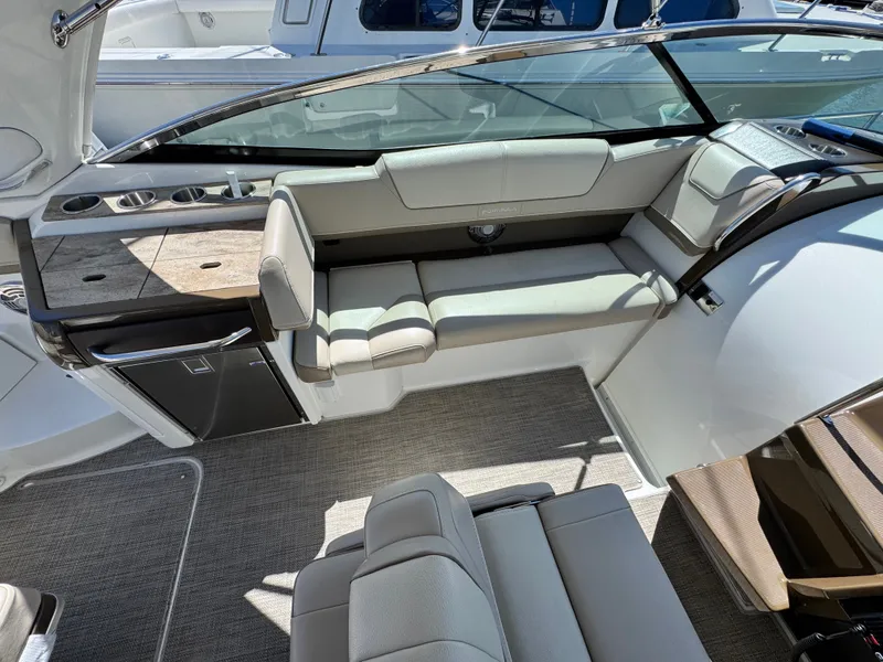 Slide: The Image of 2018 Formula 310 Sun Sport boat dashboard with steering wheel and navigation controls. - 9