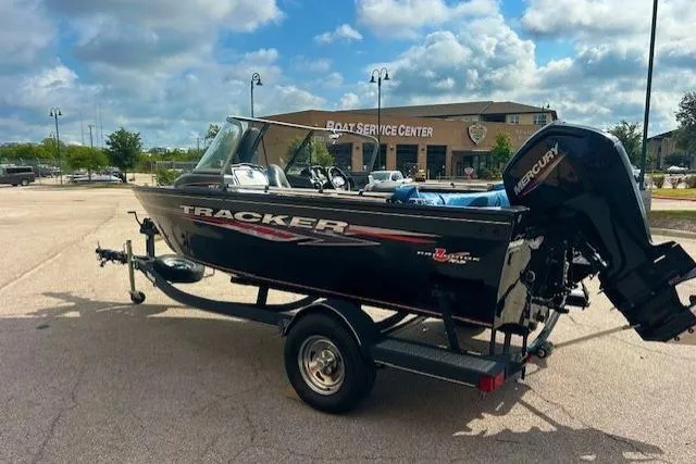 Slide: The Image of 2020 Tracker Pro Guide V-165 WT boat on trailer near service center. - 3