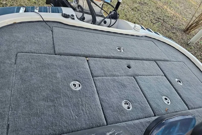 Slide: The Image of 2008 Ranger Z520 Comanche boat deck with gray carpet and storage compartments. - 10