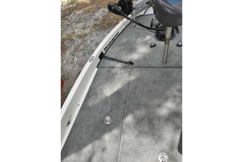 Slide: The Image of 2008 Ranger Z520 Comanche boat deck with gray carpet and seating area. - 11