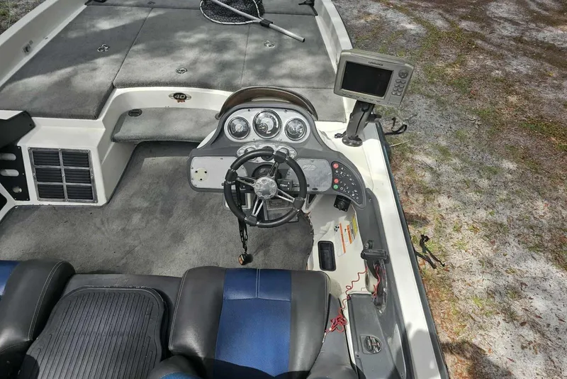 Slide: The Image of 2008 Ranger Z520 Comanche boat cockpit with steering wheel and fishfinder display. - 4