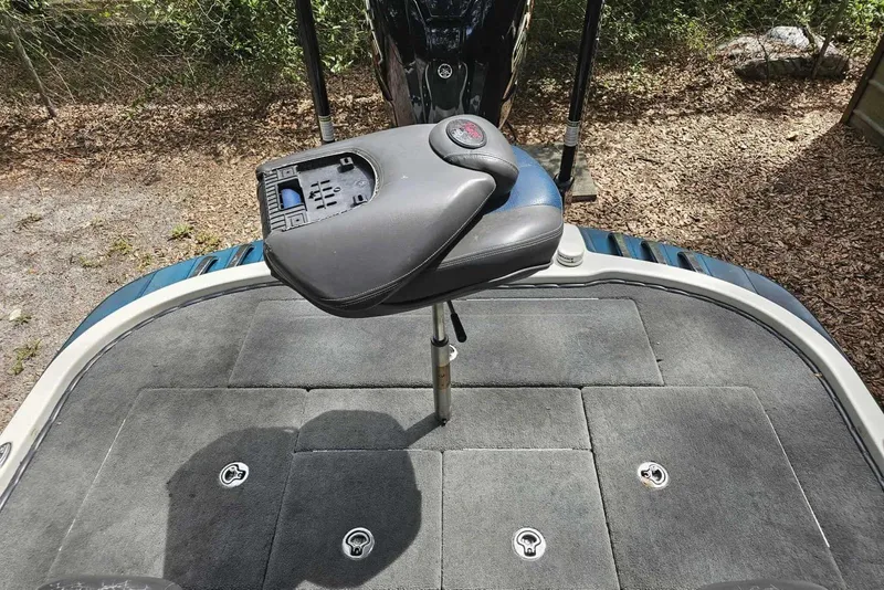 Slide: The Image of 2008 Ranger Z520 Comanche boat deck with seat and motor, outdoor setting. - 8