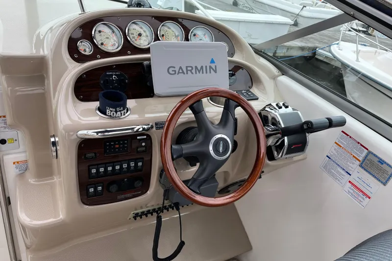 Slide: The Image of 2005 Chaparral 270 Signature boat dashboard with Garmin GPS and wooden steering wheel. - 3