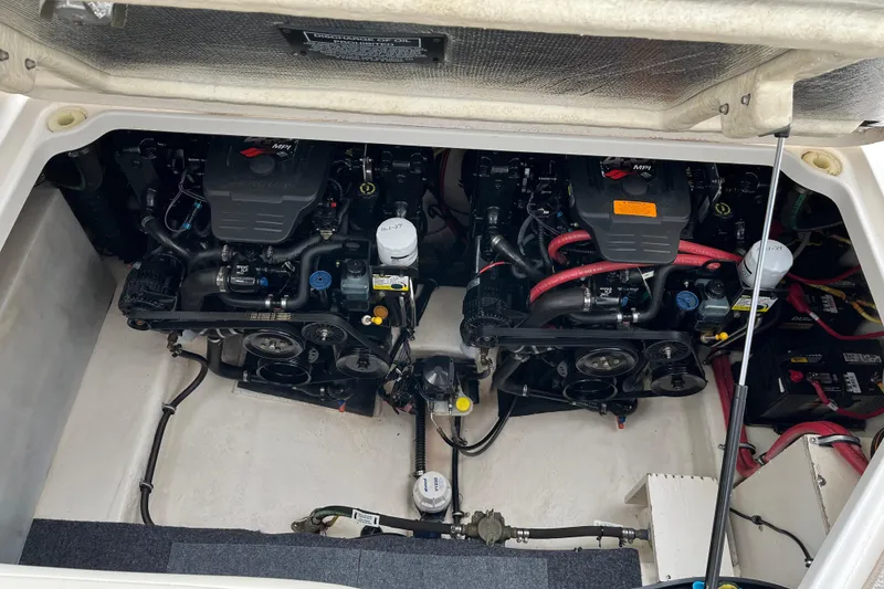 Slide: The Image of Engine compartment of a 2005 Chaparral 270 Signature boat, featuring dual engines. - 5