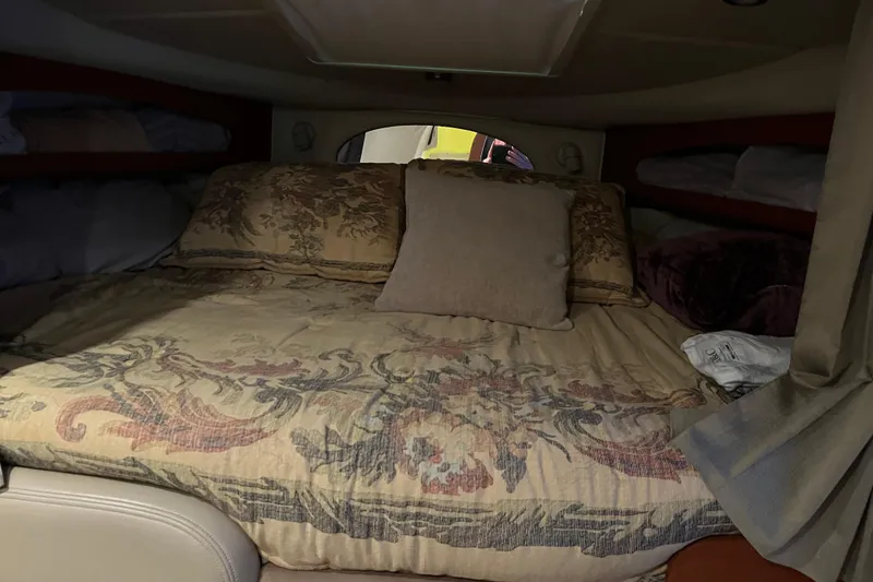 Slide: The Image of Cozy cabin interior of 2005 Chaparral 270 Signature with floral bedding. - 6
