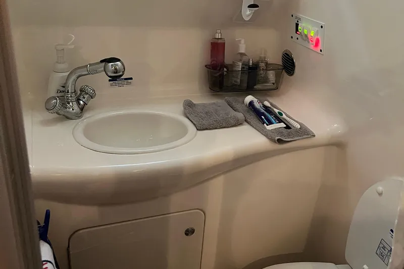Slide: The Image of 2005 Chaparral 270 Signature bathroom with sink, toiletries, and control panel. - 7