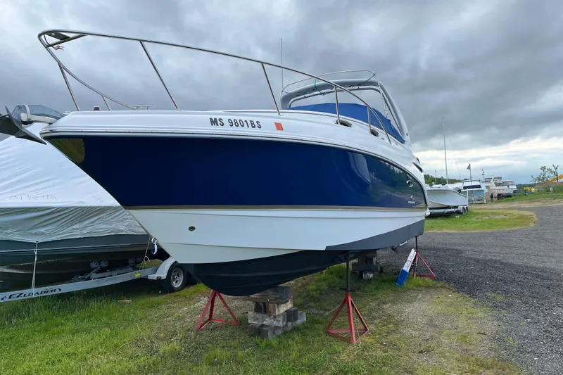 Slide: The Image of 2005 Chaparral 270 Signature boat on stands, cloudy sky background. - 9