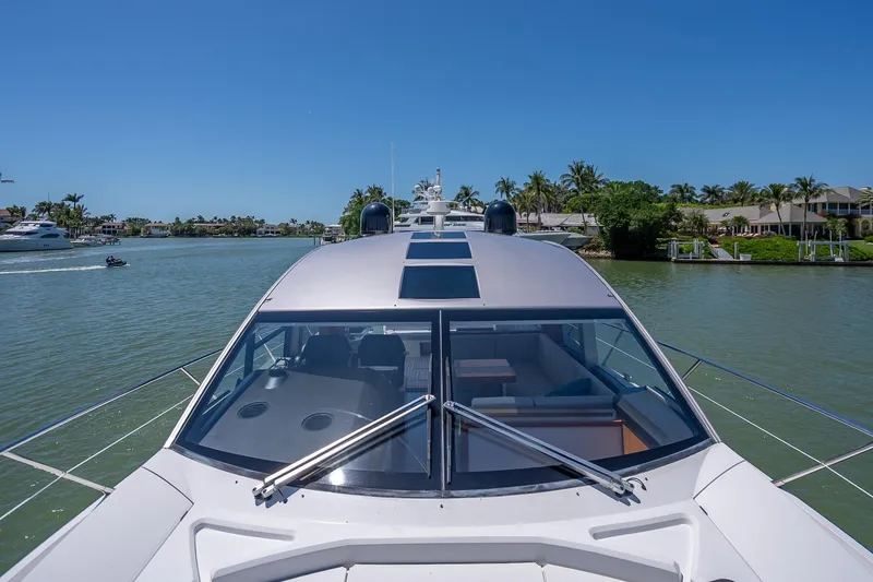 Slide: The Image of 2018 Sunseeker Predator 57 yacht cruising on a sunny day in a scenic waterway. - 32