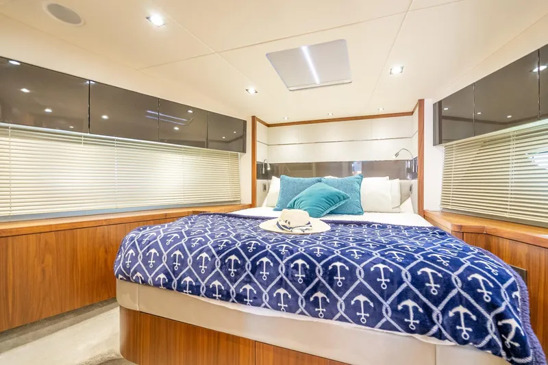 Slide: The Image of Luxurious bedroom interior of 2018 Sunseeker Predator 57 yacht with nautical-themed decor. - 79