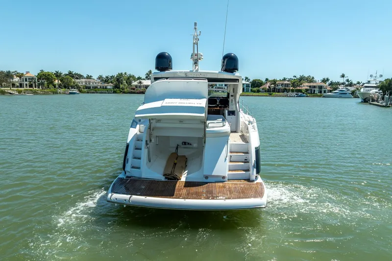 Slide: The Image of 2018 Sunseeker Predator 57 yacht cruising on a sunny day in a scenic waterfront area. - 20