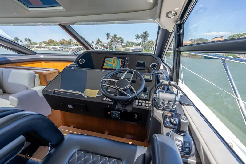 Slide: The Image of Helm of 2018 Sunseeker Predator 57 yacht with modern navigation equipment and luxurious seating. - 63